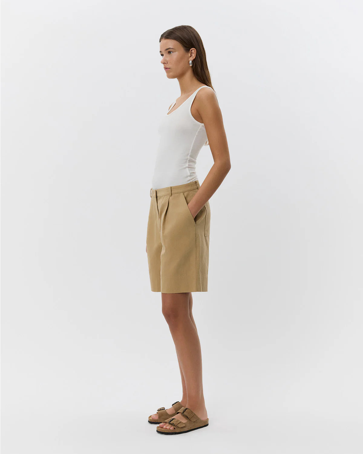 woman wearing camel khaki knee length shorts