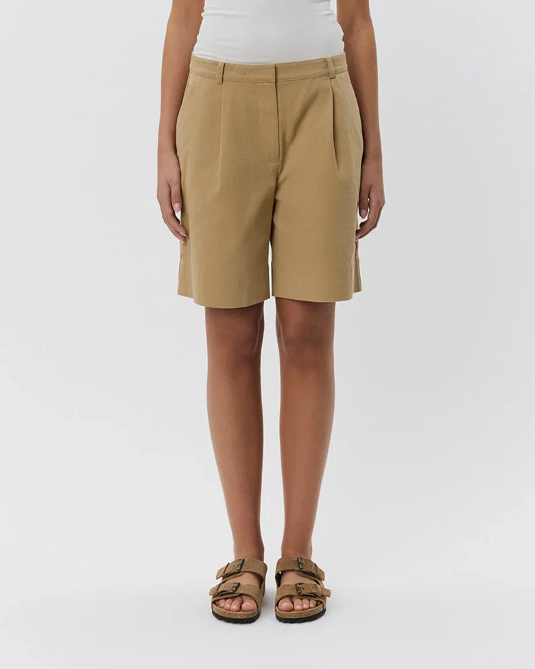 woman wearing camel khaki long shorts