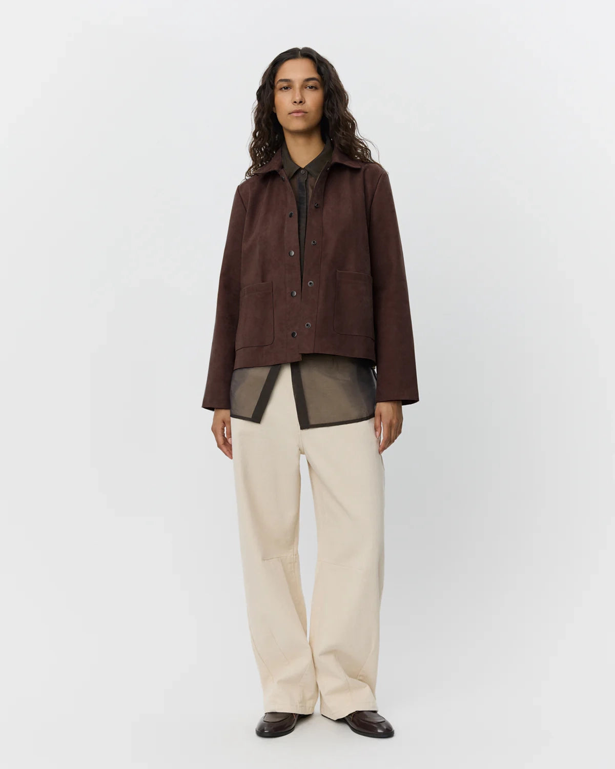 a woman wearing a brown suede jacket by sofie schnoor