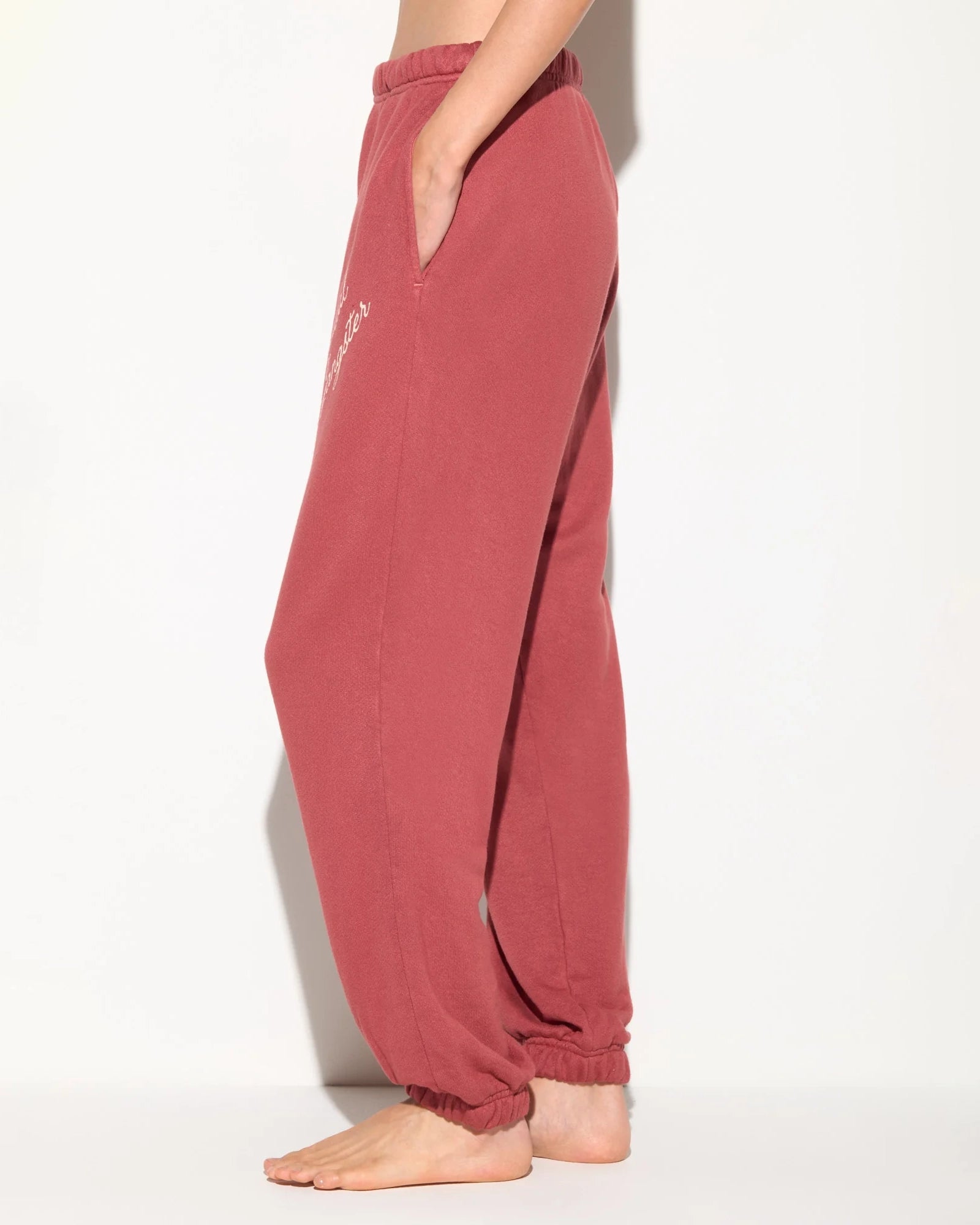 Rust coloured sweatpants with 'Spiritual Gangster' text on them