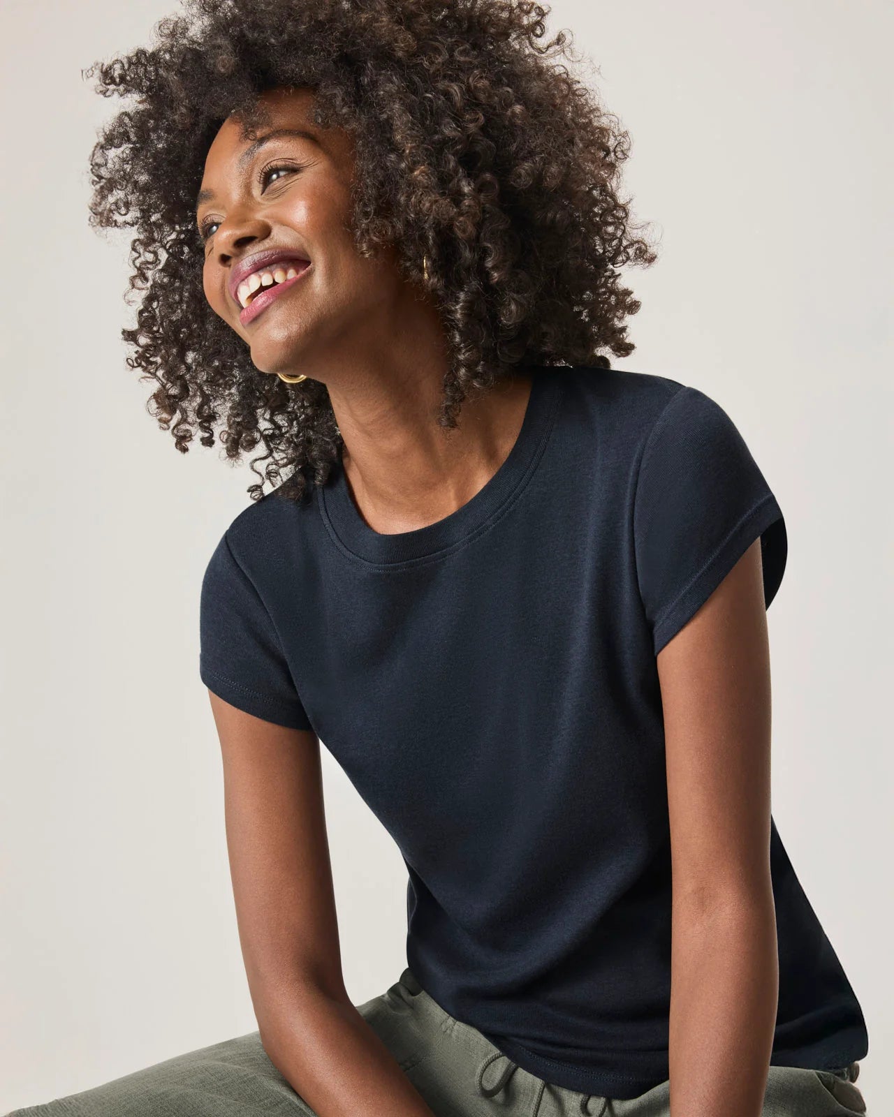 a woman wearing a classic crew neck navy tshirt