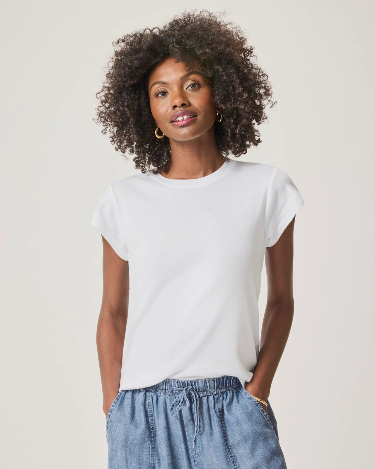 a woman wearing a classic crew neck white tshirt