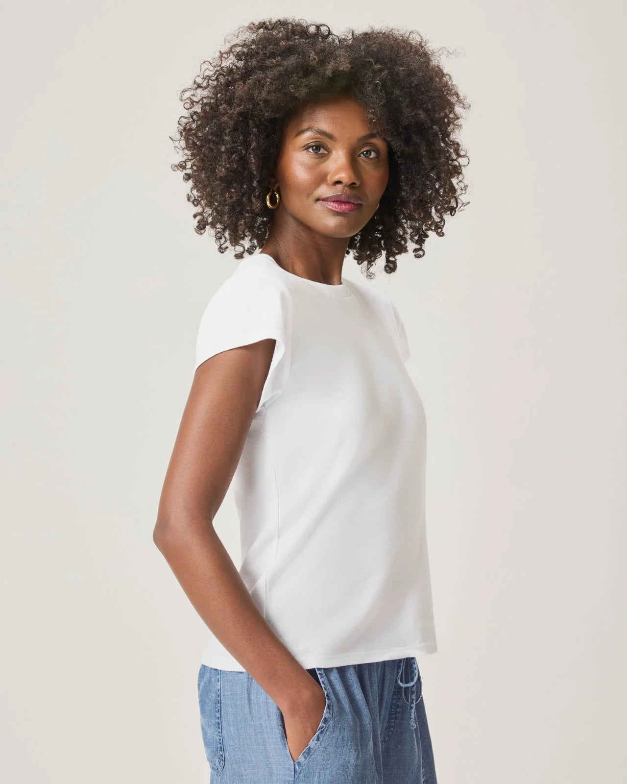 a woman wearing a classic crew neck white tshirt
