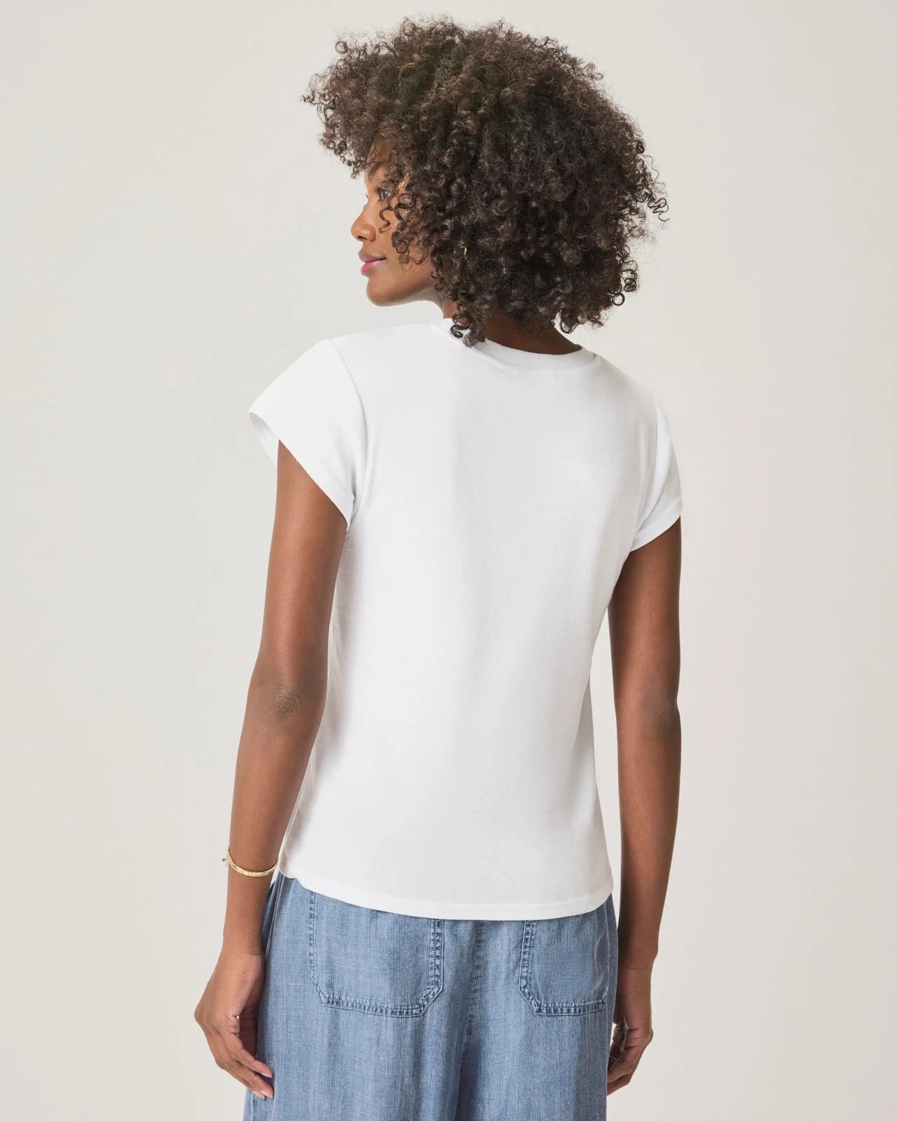 a woman wearing a classic crew neck white tshirt