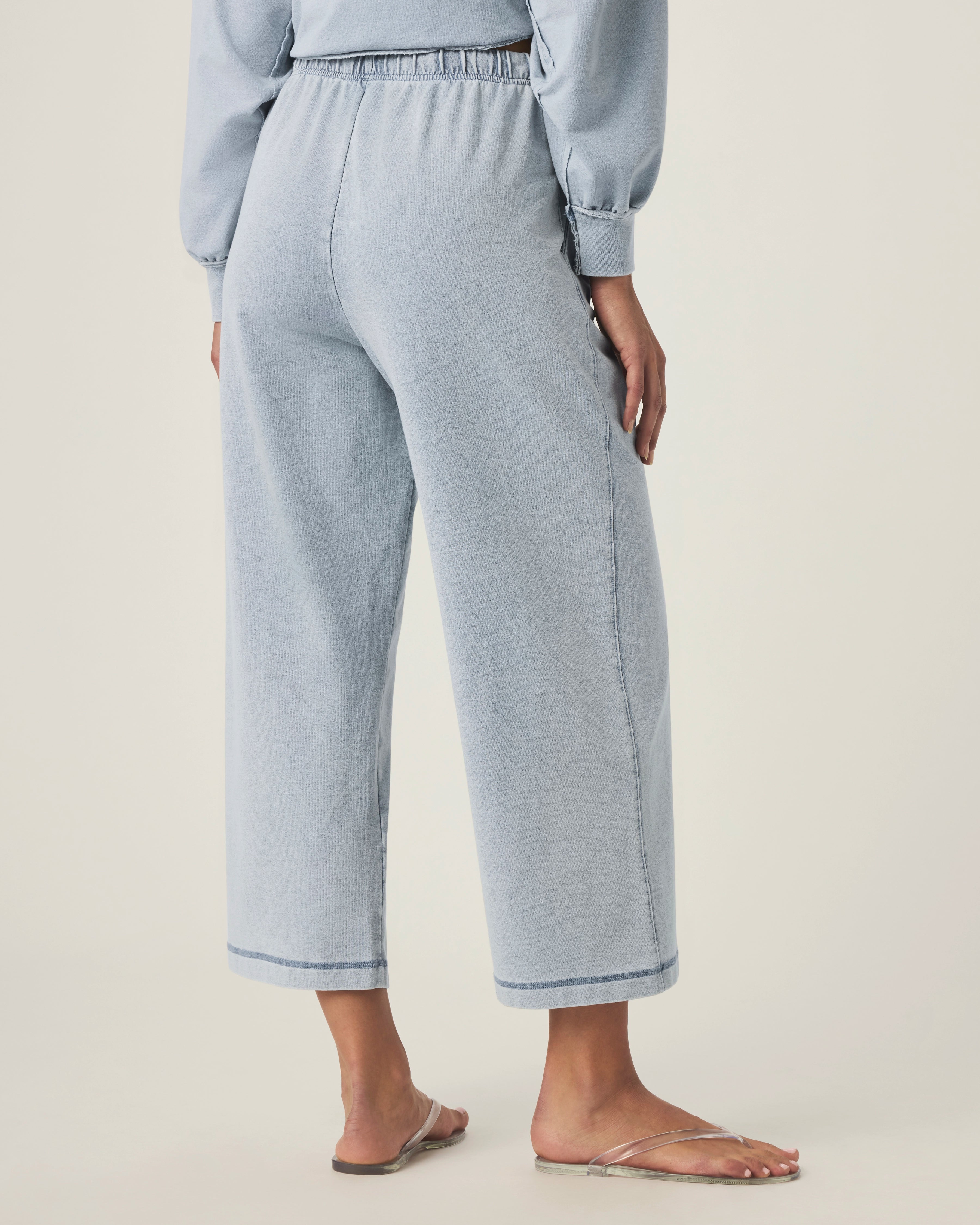 person wearing light blue grey terry pants with drawstring and elastic waistband