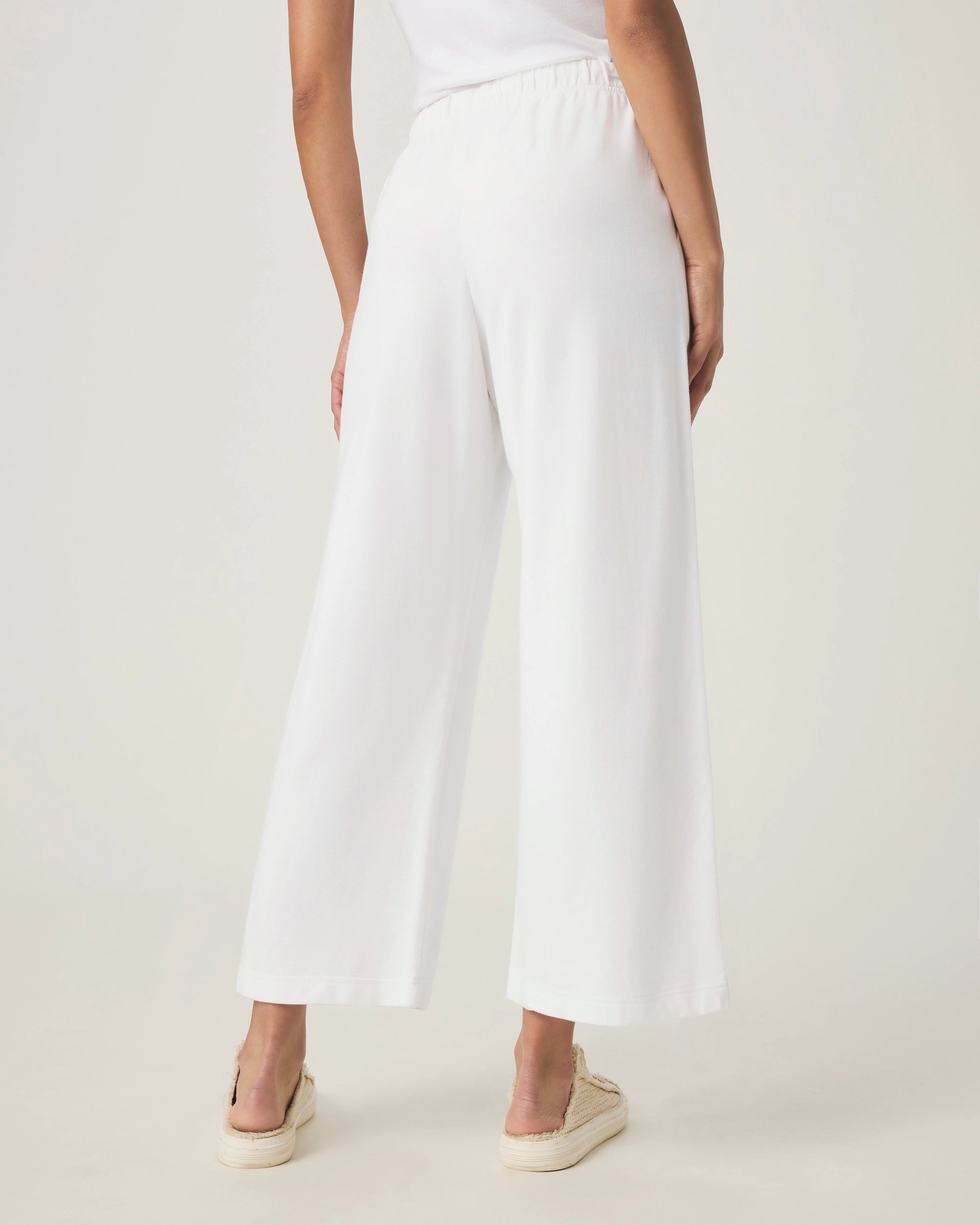 woman wearing white wide-leg terry cloth drawstring pants