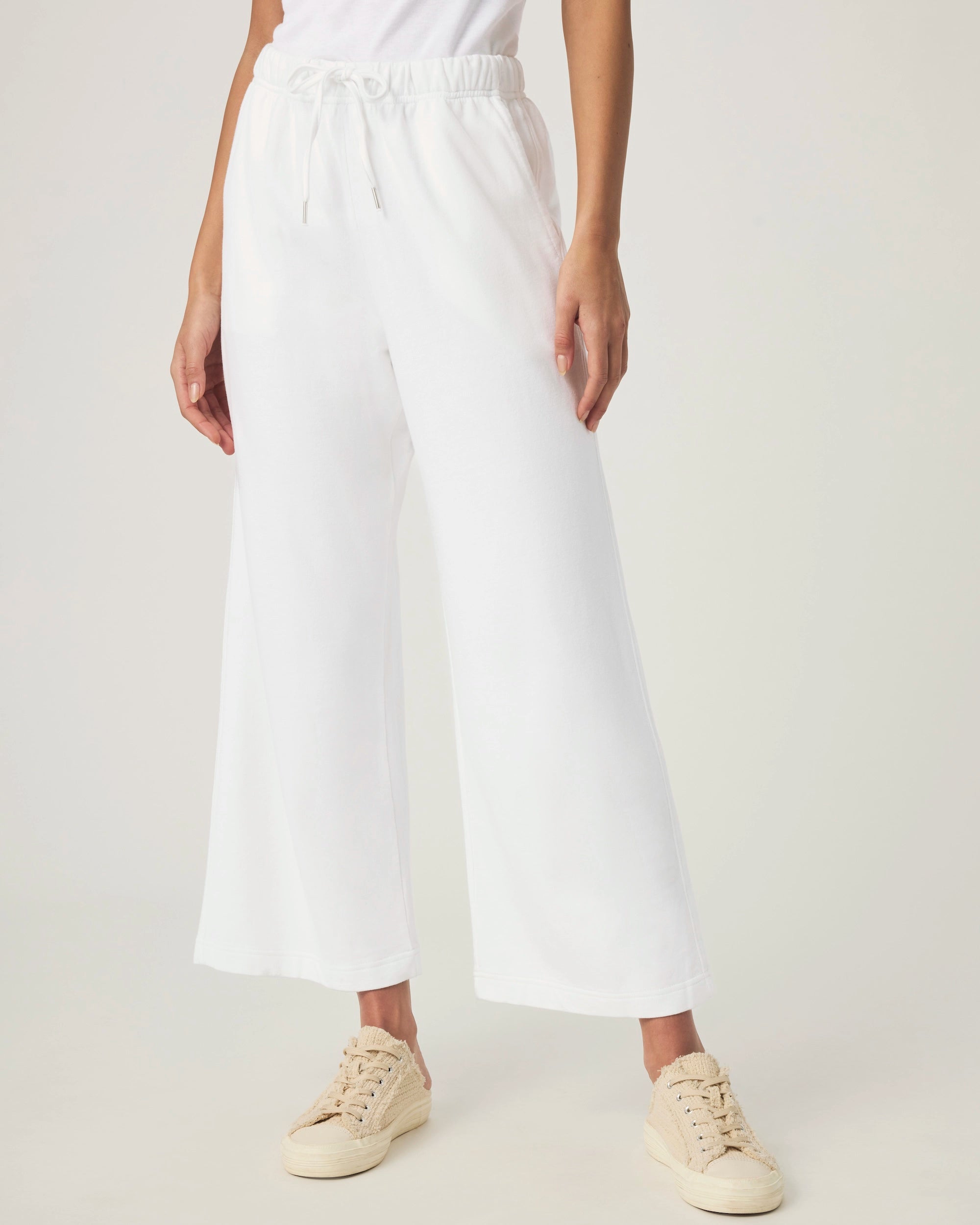 woman wearing white wide-leg terry cloth drawstring pants