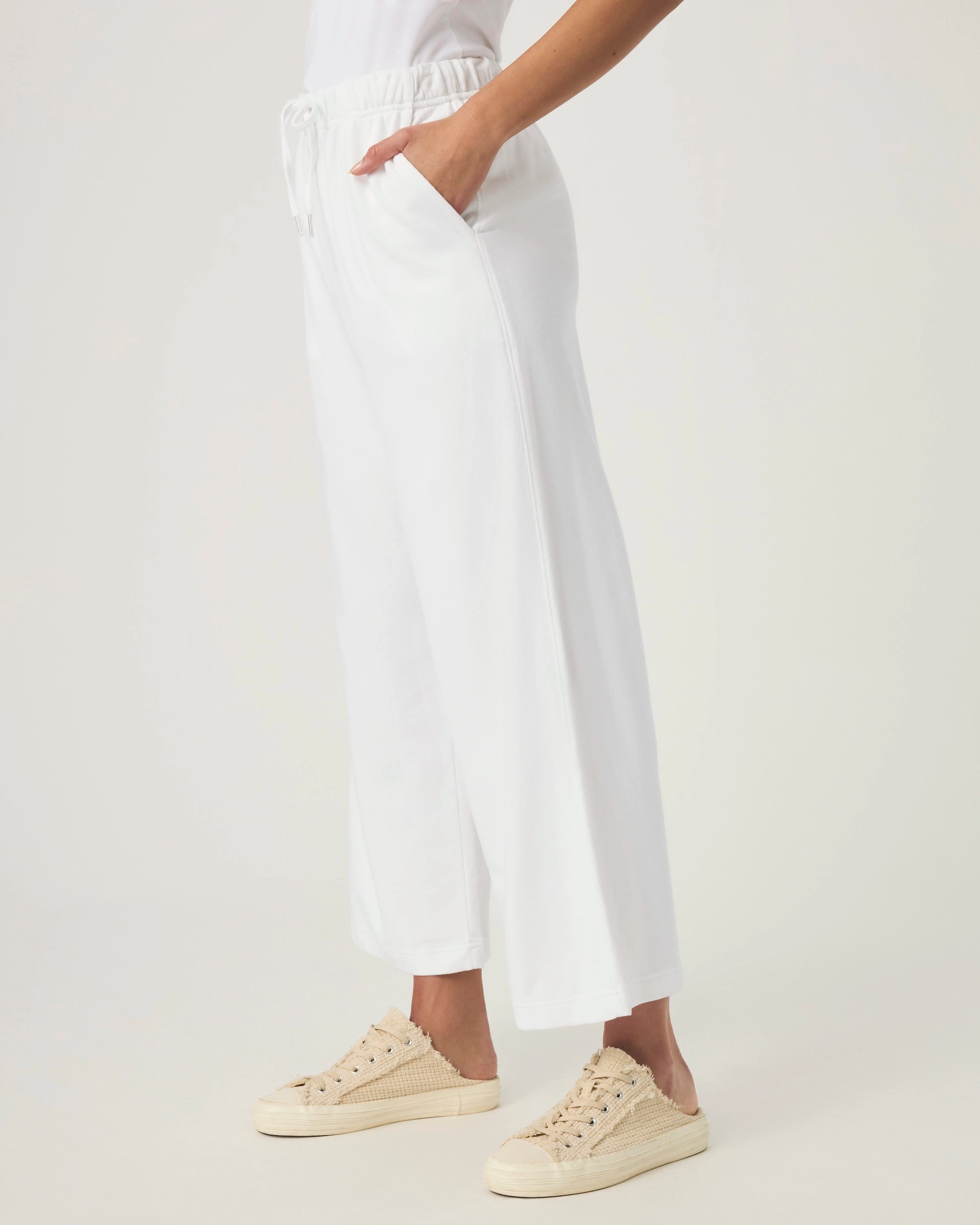 woman wearing white wide-leg terry cloth drawstring pants
