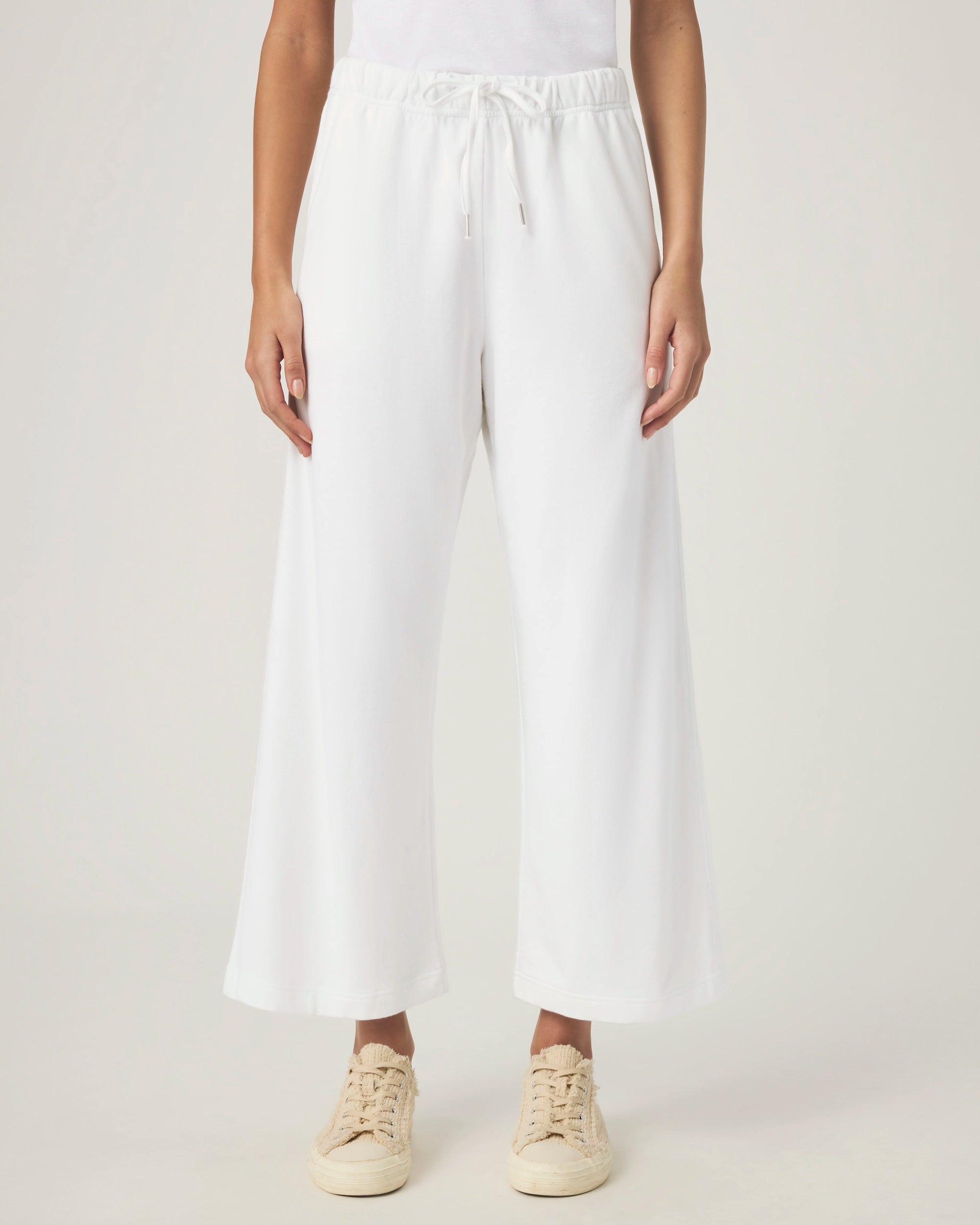 woman wearing white wide-leg terry cloth drawstring pants