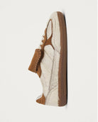 pair of pony hair cream and tan leather sneakers with a rubber sole