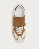 pair of pony hair cream and tan leather sneakers with a rubber sole