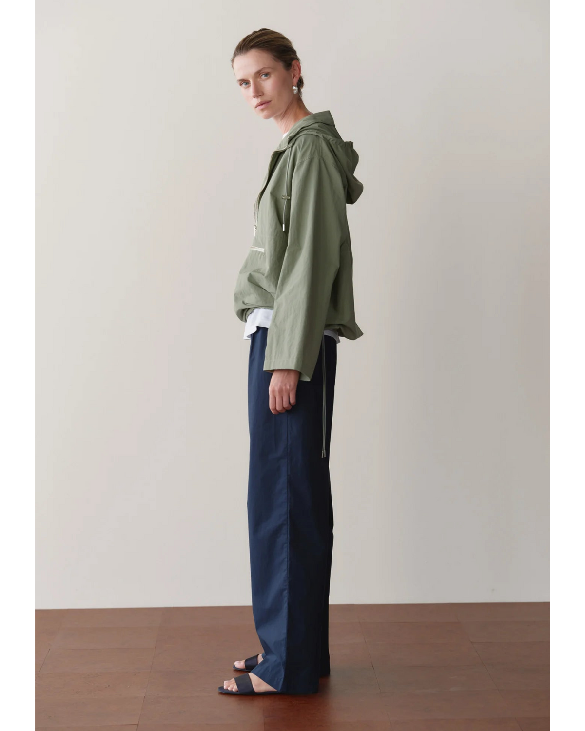 green rain jacket with wide sleeves and a hood