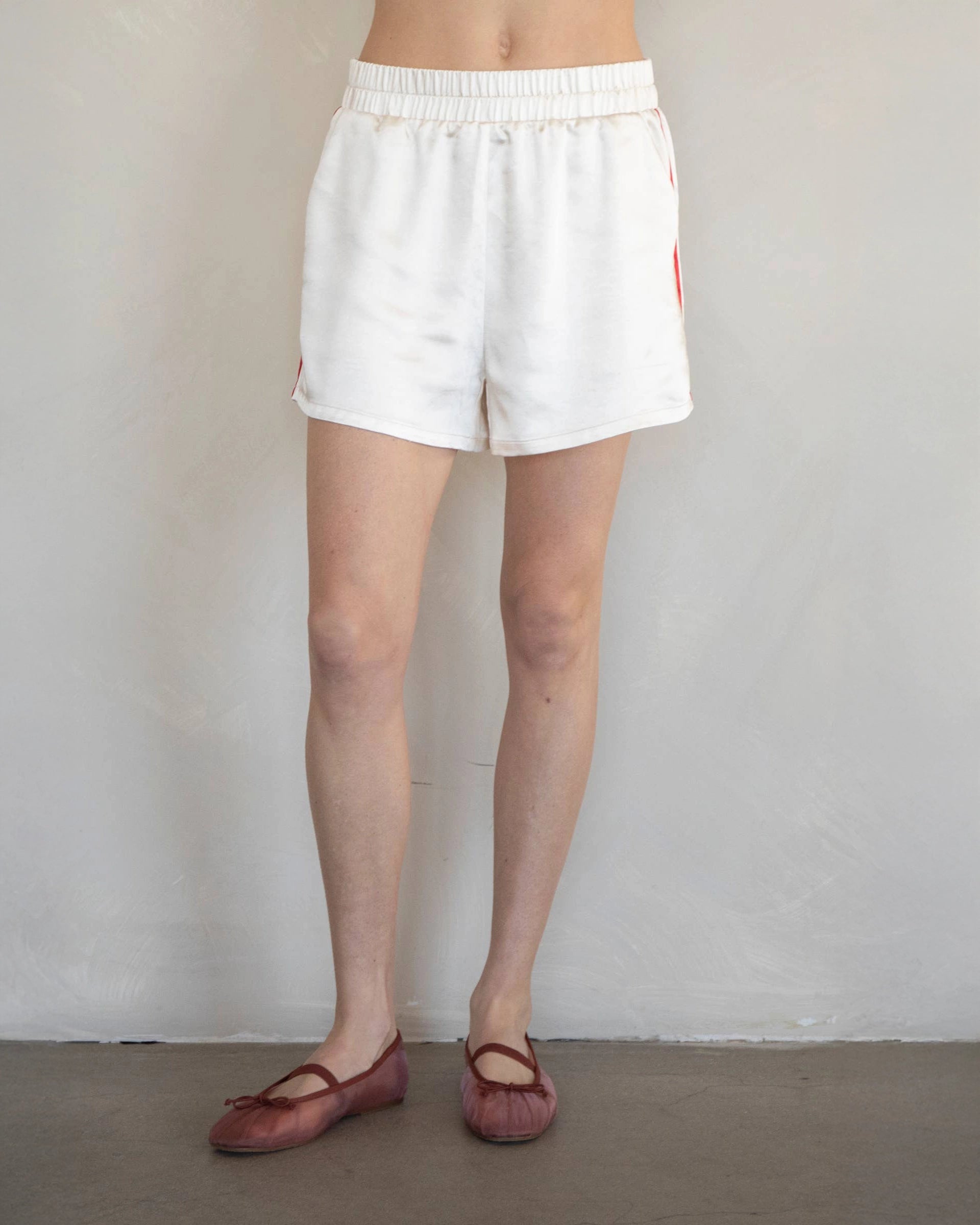 White Shorts with red stripes down the side with elastic waist
