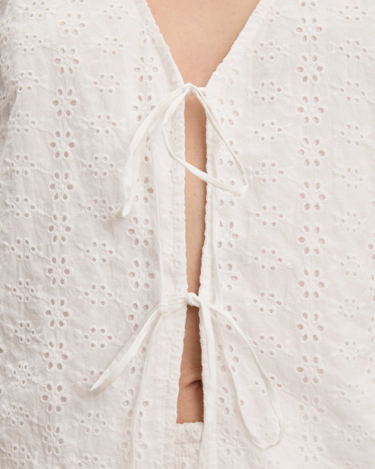 White embroidered blouse with a tie detail