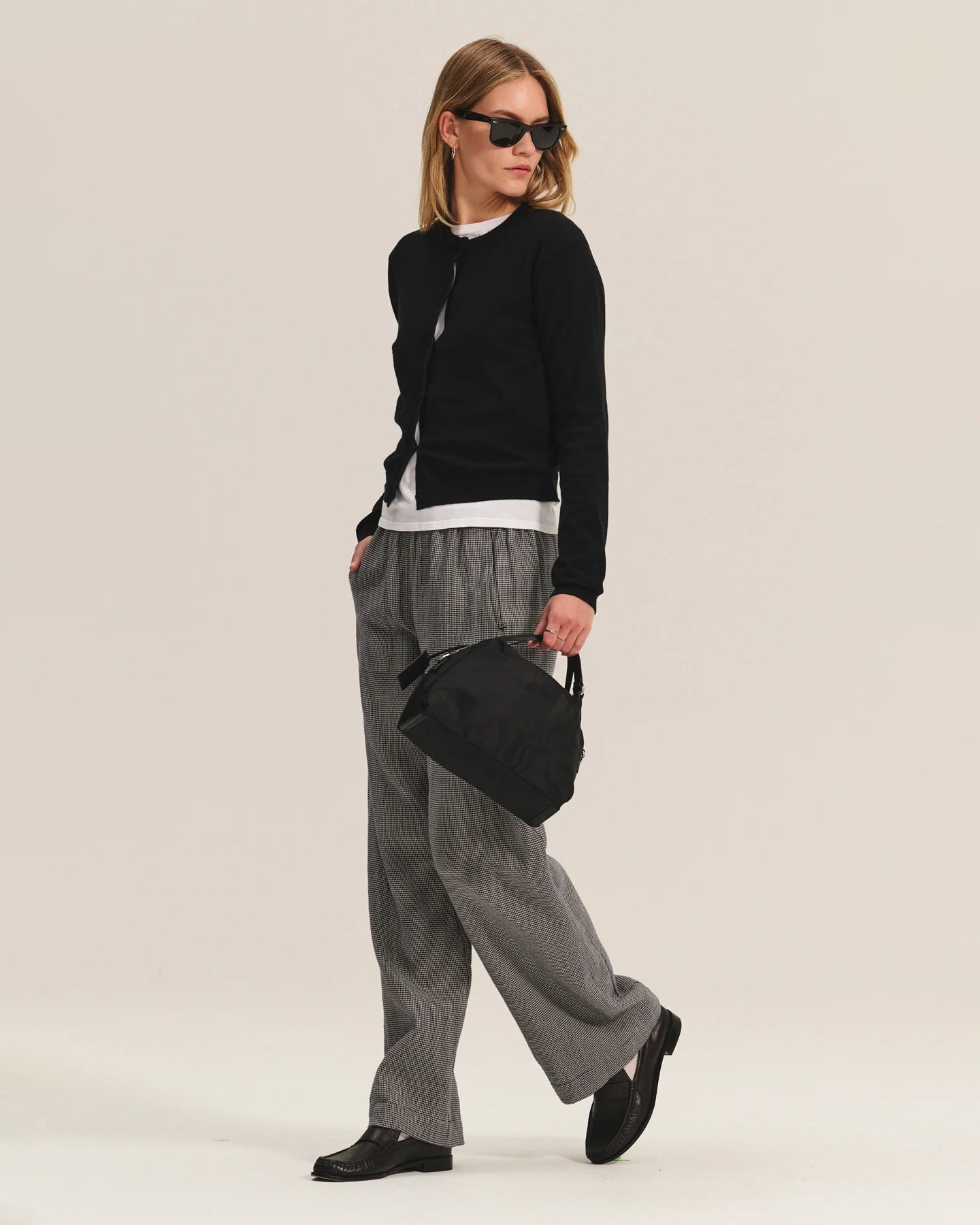 Person wearing gray wide-leg pants