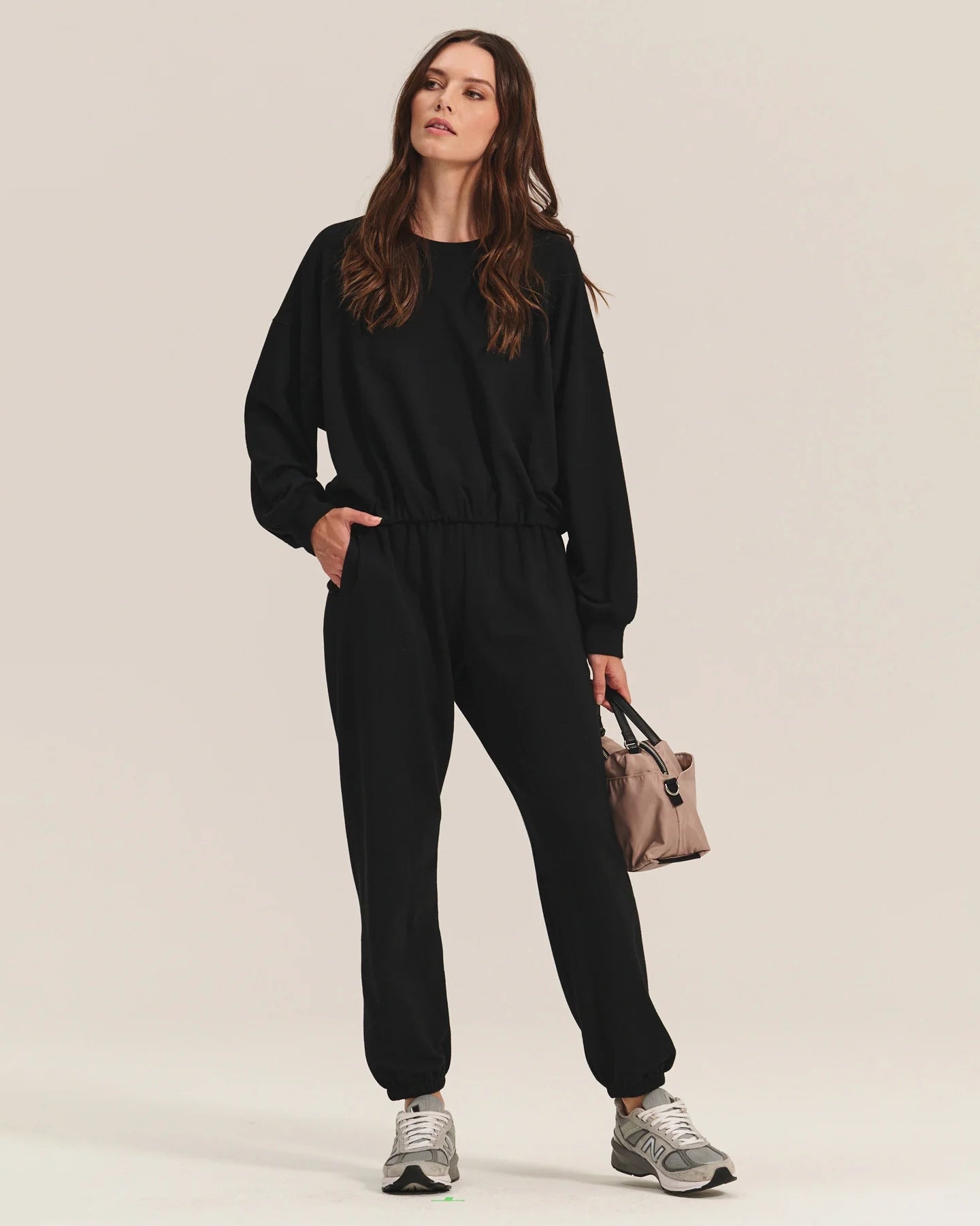 woman wearing black cotton sweatpants with a matching sweatshirt