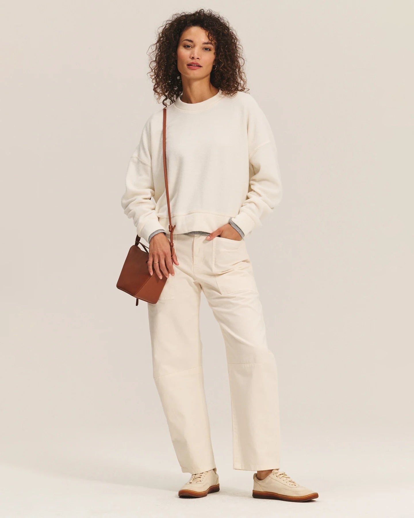 Woman wearing a cream sherpa textured sweater