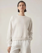 woman wearing a light gray sweatshirt