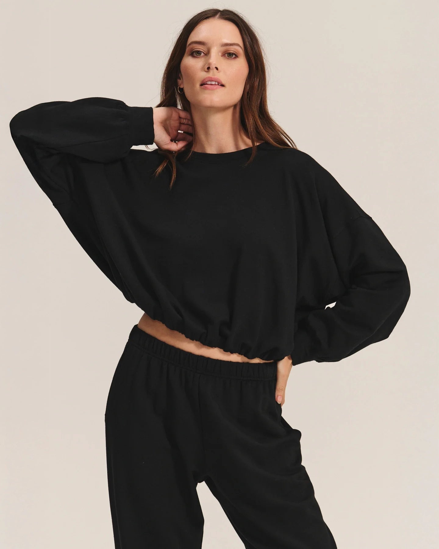 Woman wearing a black cotton sweatshirt with matching joggers