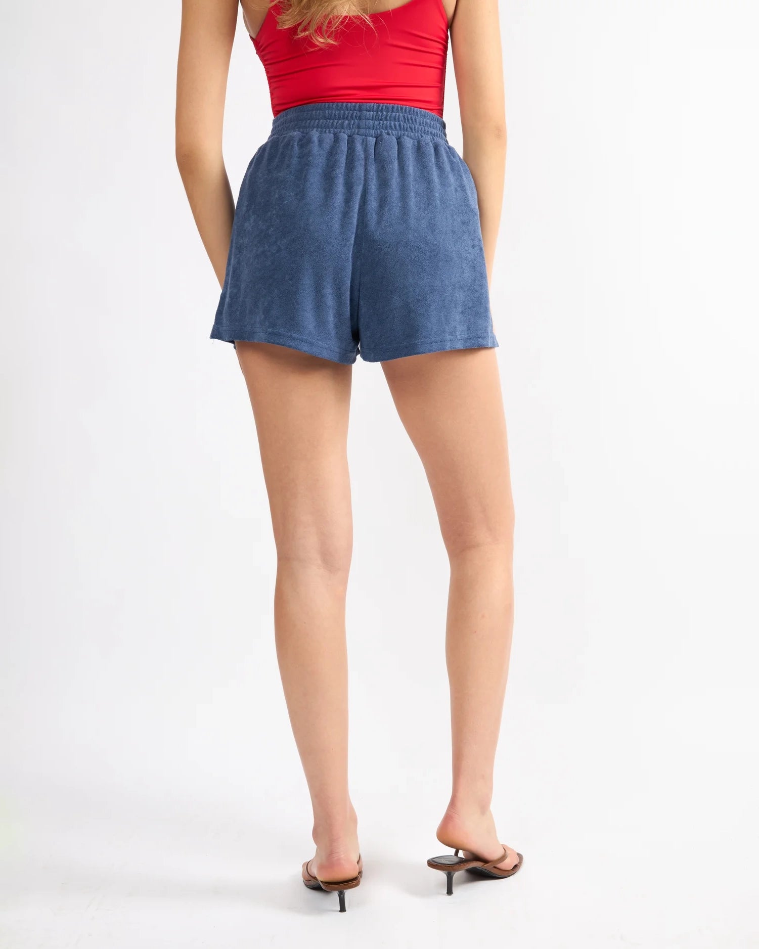 woman wearing blue terry cloth shorts