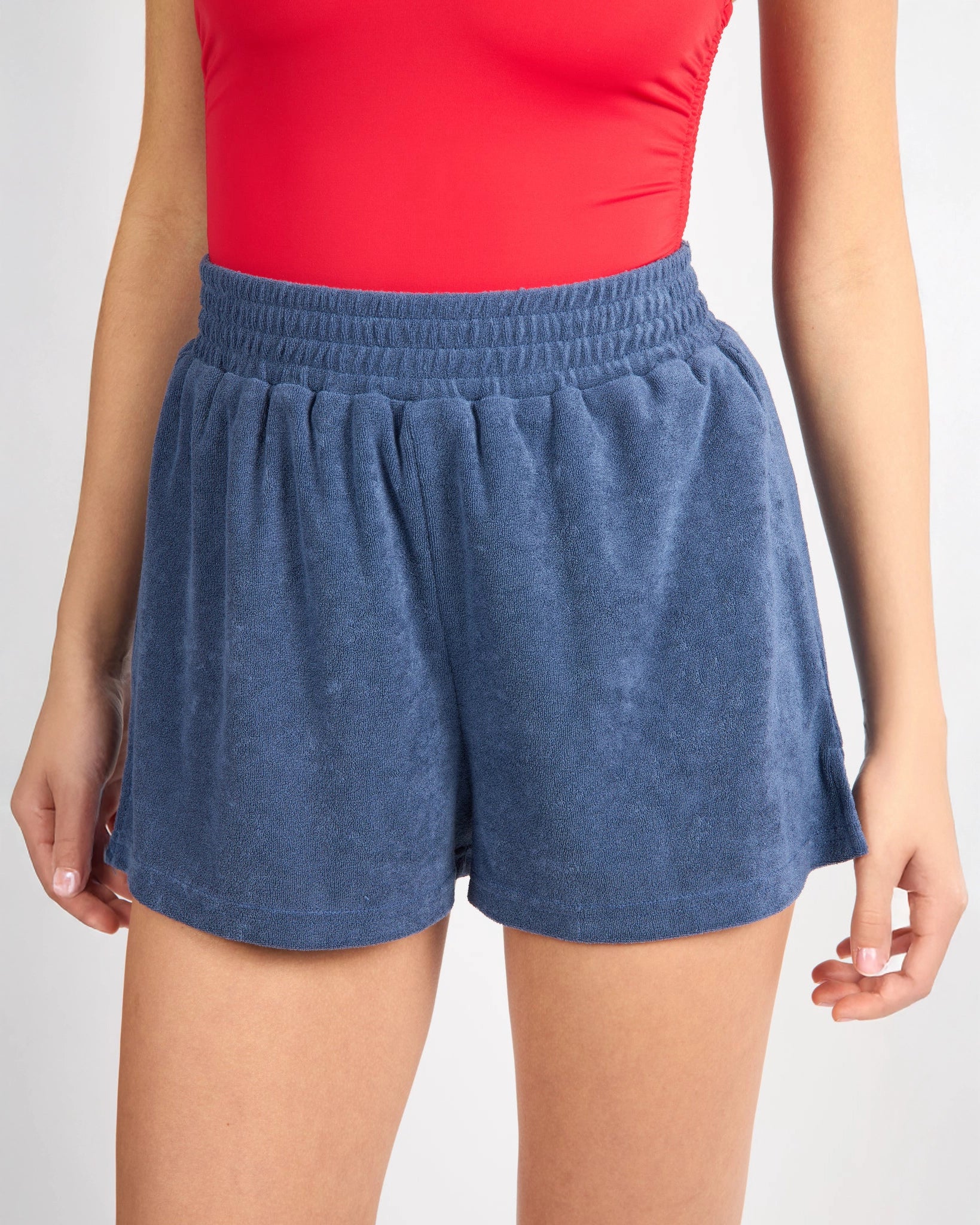 woman wearing blue terry cloth shorts