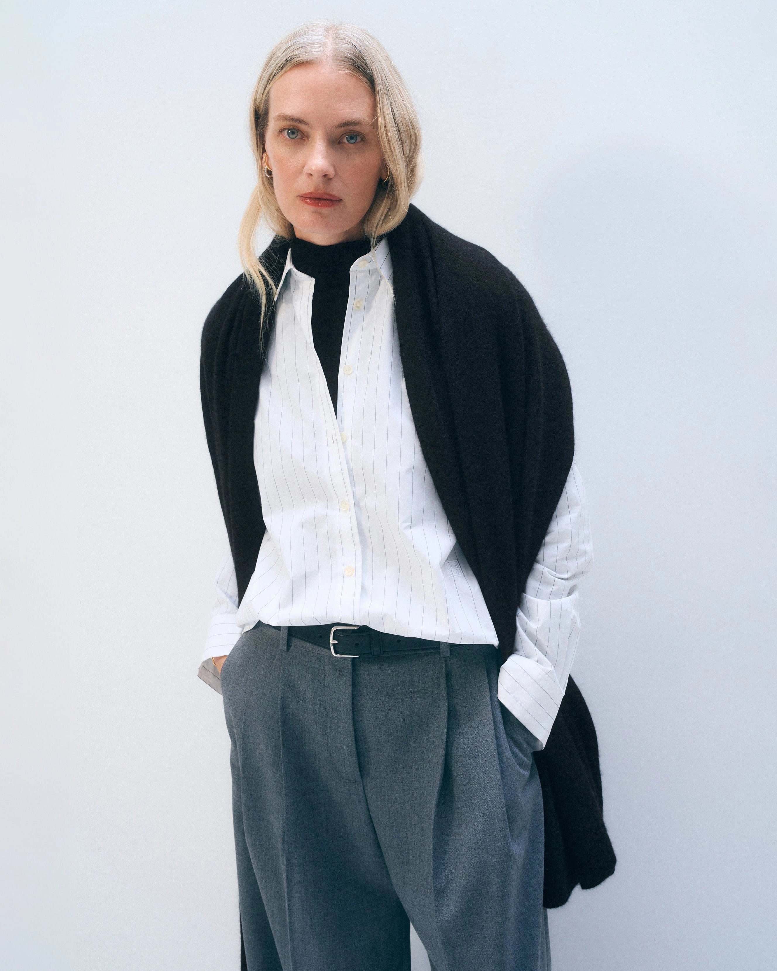 a woman wears a large cashmere wrap scarf in black