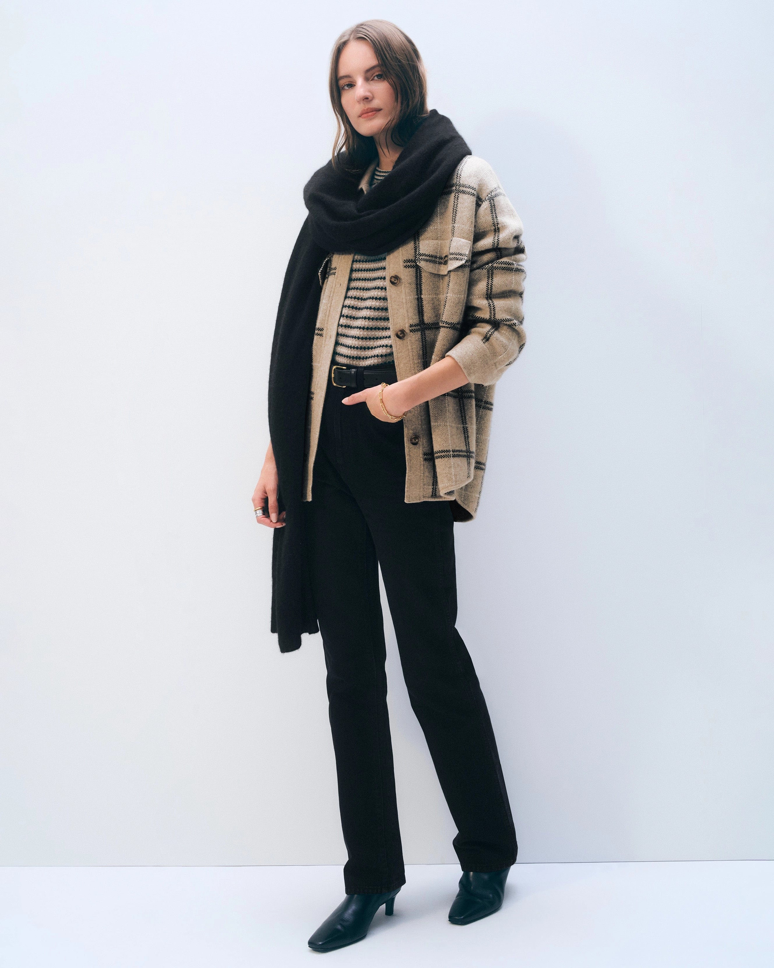 a woman wears a large cashmere wrap scarf in black