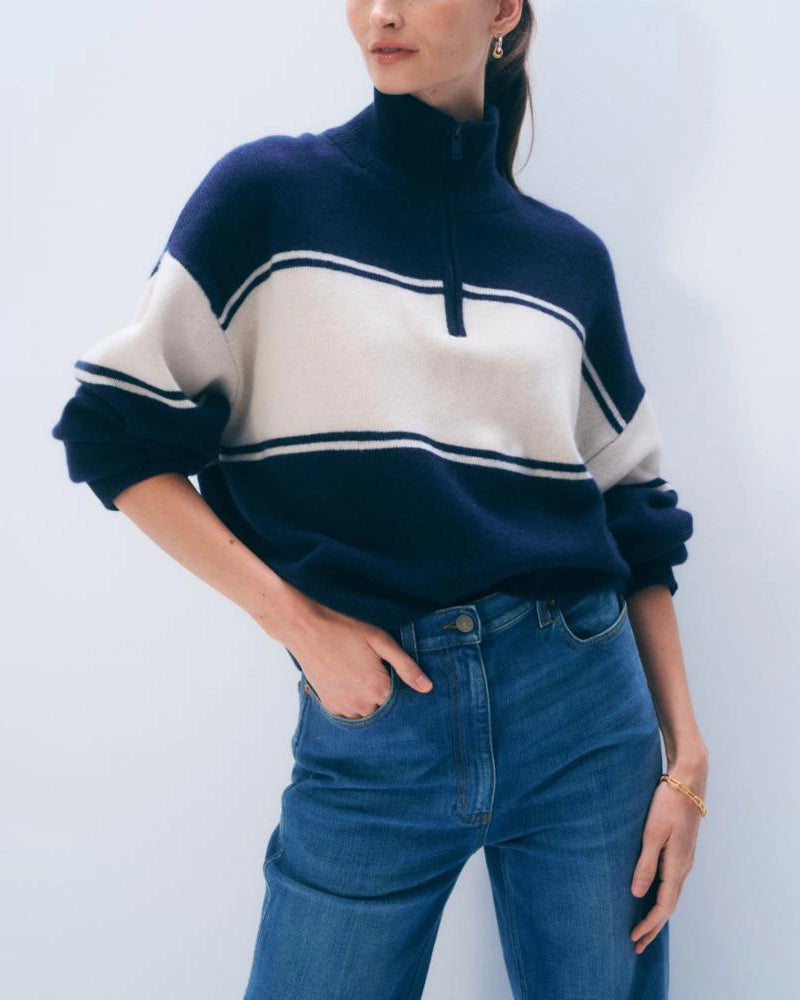 Woman wearing a navy and white striped cashmere sweater with quarter zip