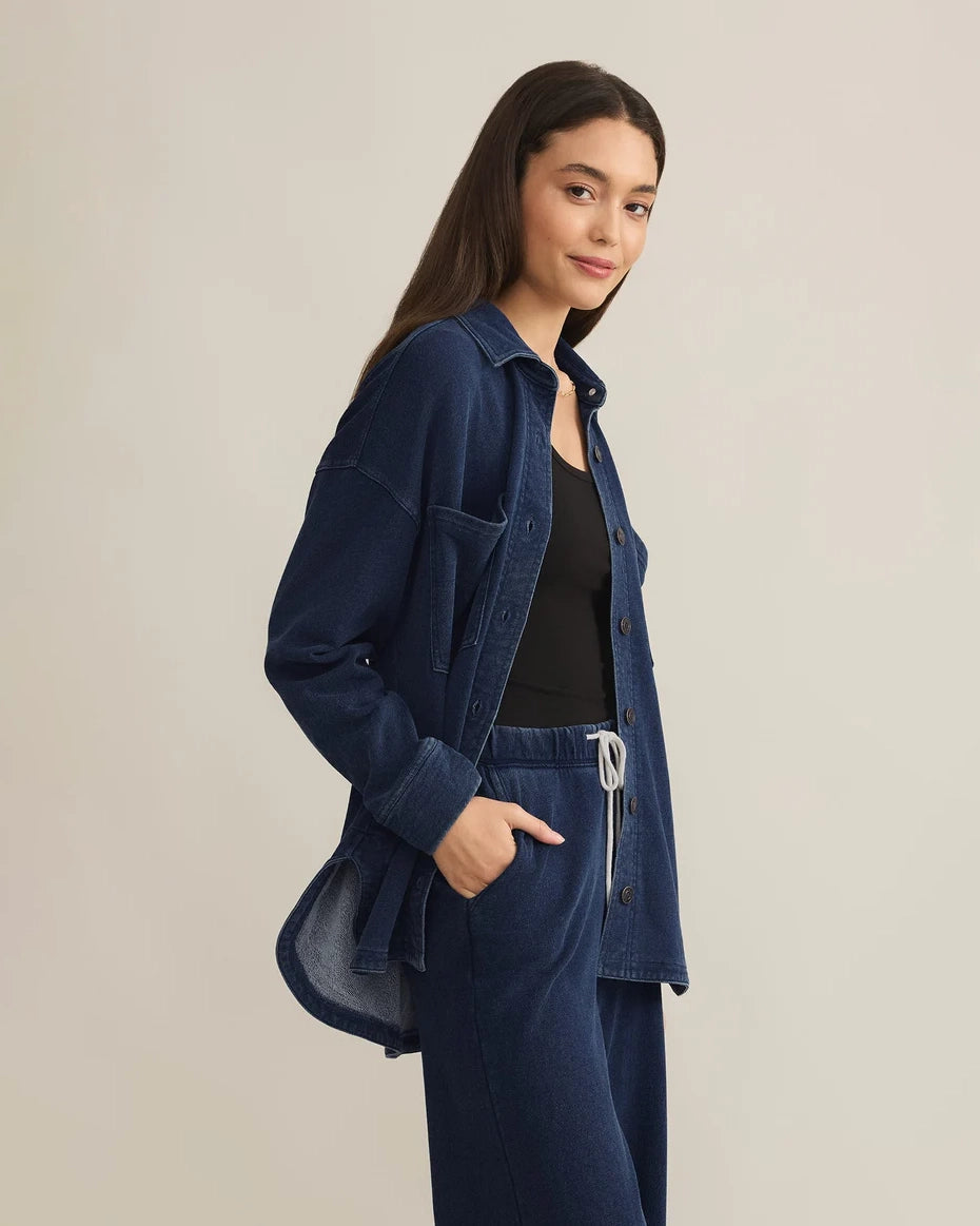 Woman wearing a blue denim button down jacket and drawstring pants