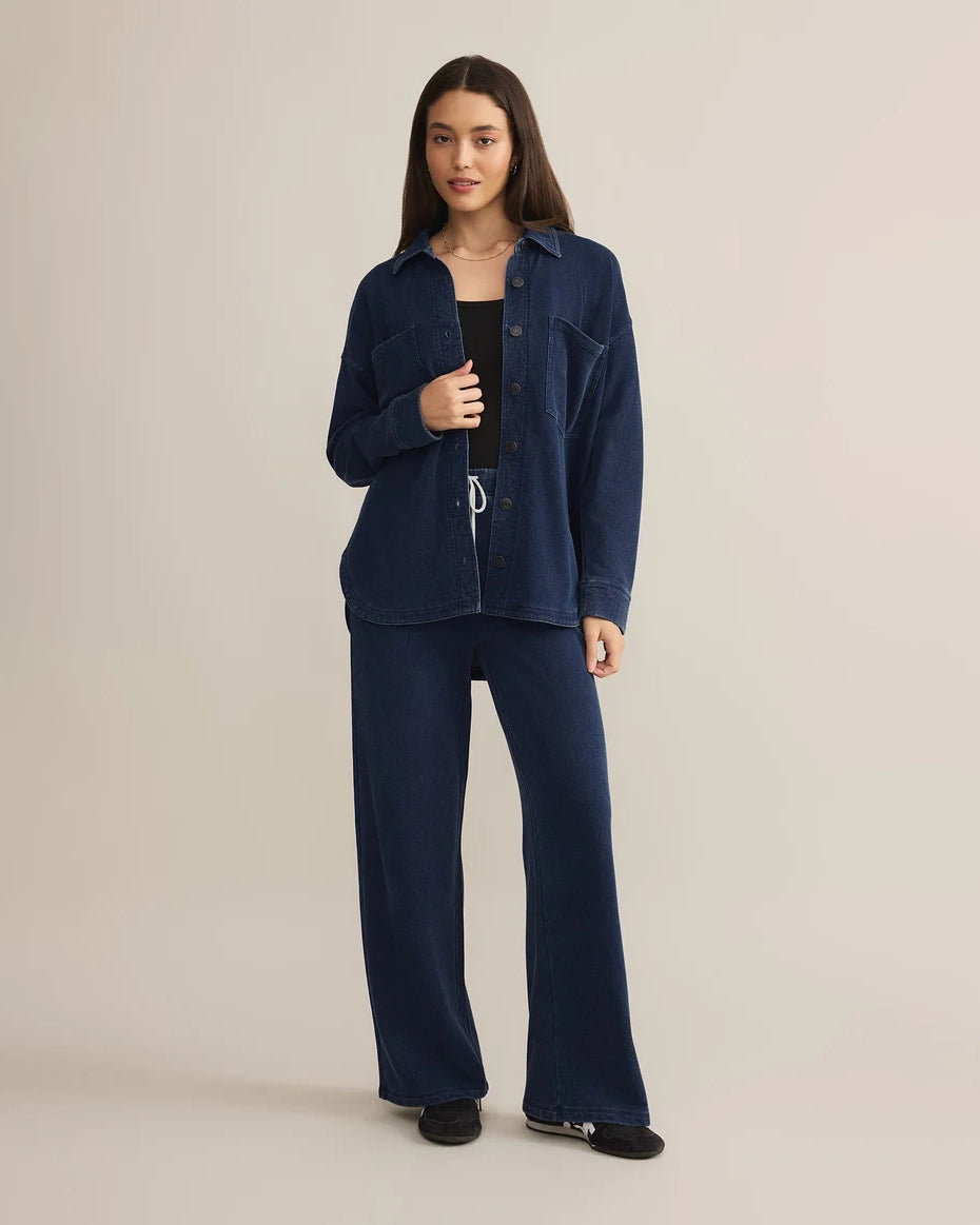 Woman wearing a blue denim button down jacket and drawstring pants