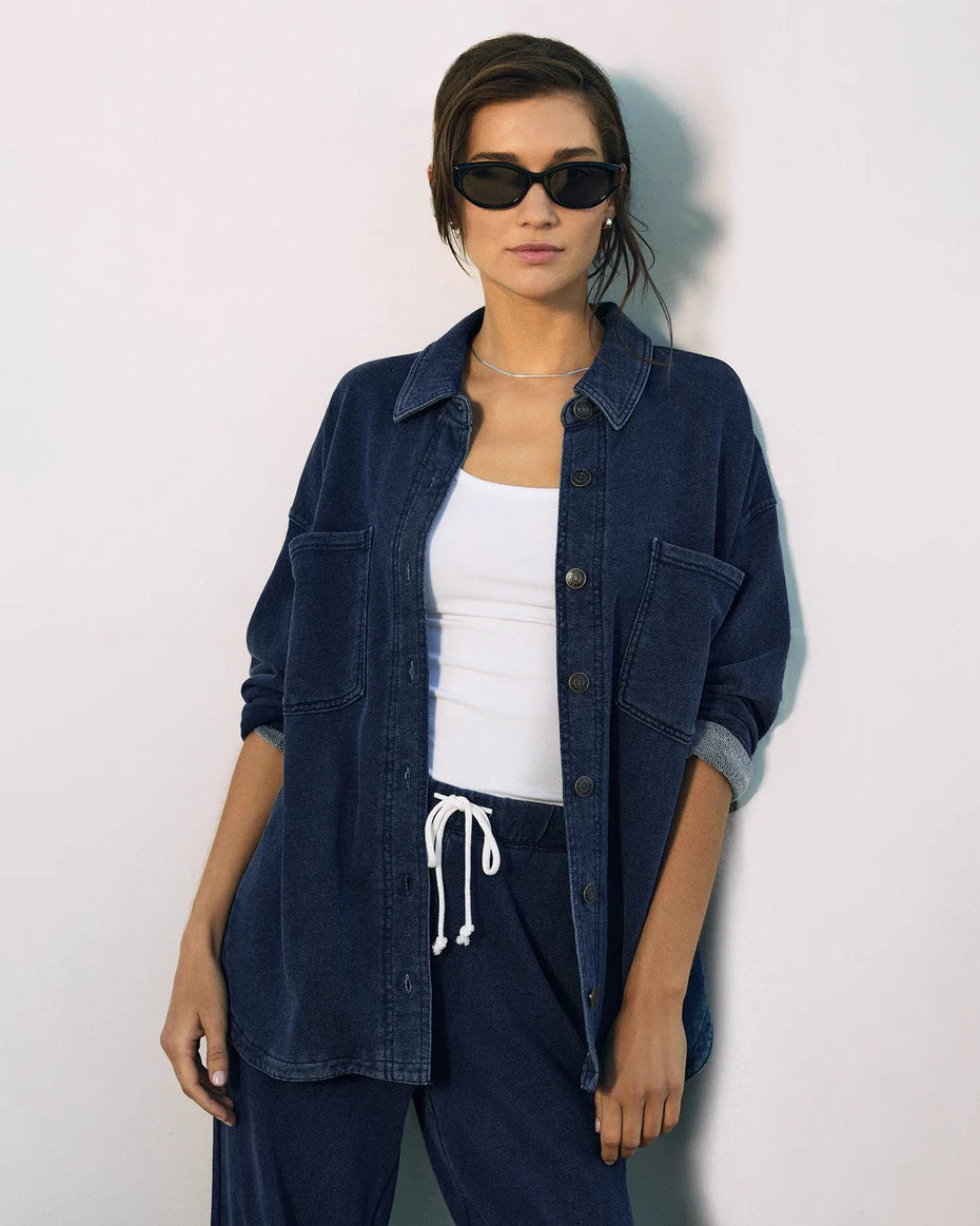 Woman wearing a blue denim button down jacket and drawstring pants