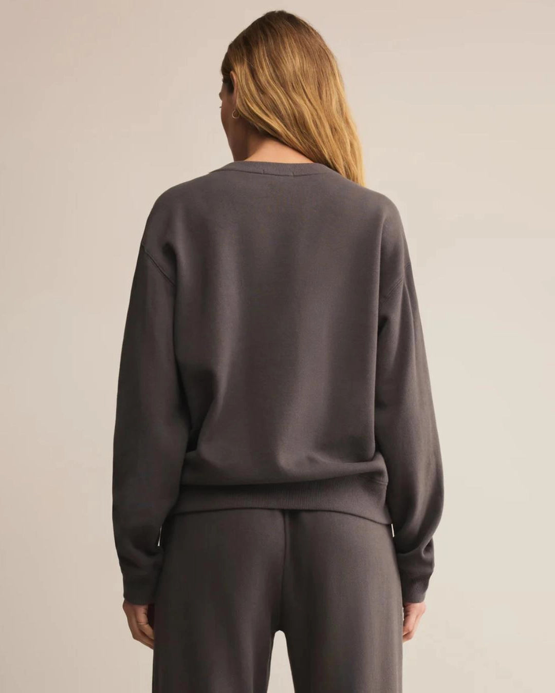 Woman wearing a dark gray cotton sweatshirt