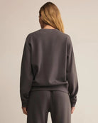 Woman wearing a dark gray cotton sweatshirt