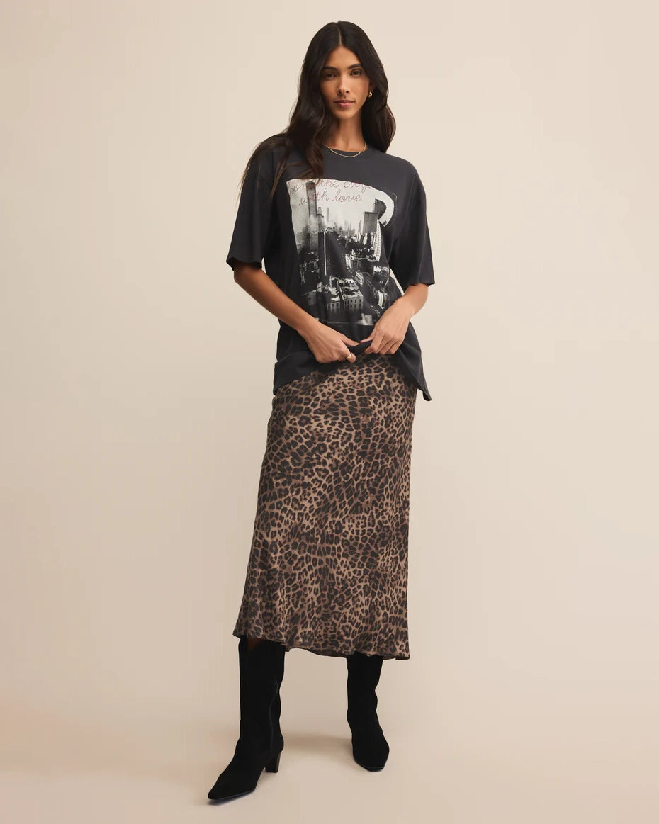 Woman wearing a graphic t-shirt and leopard print skirt
