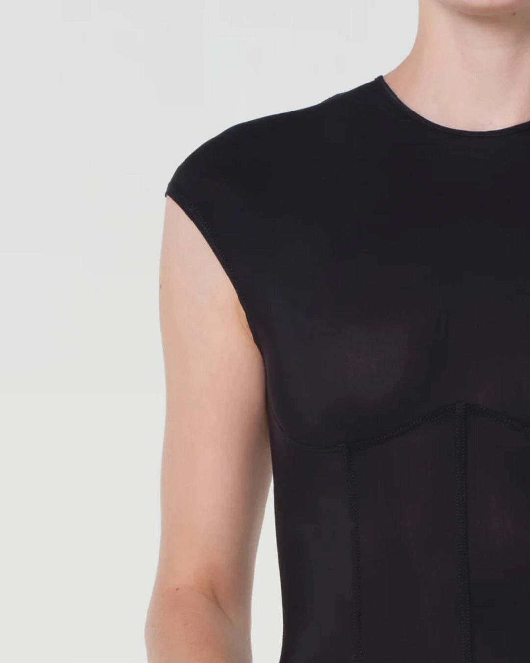 woman wearing a black bodysuit with a corset design by Agolde