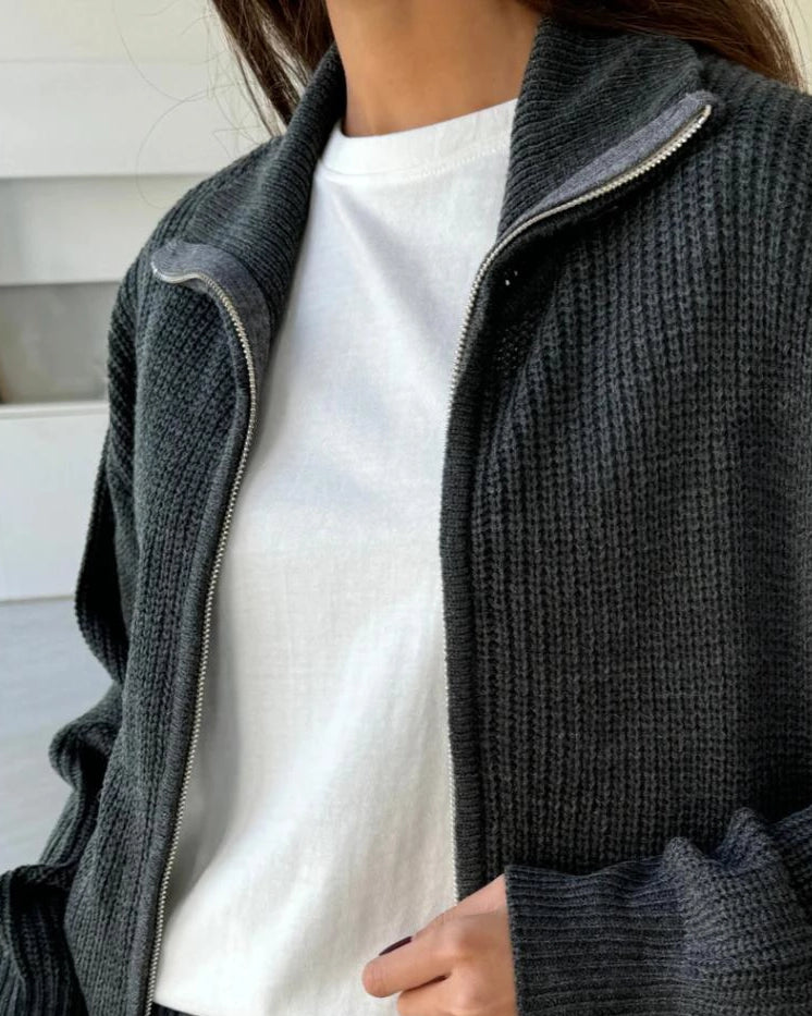 Woman wearing a dark gray zip up knit jacket