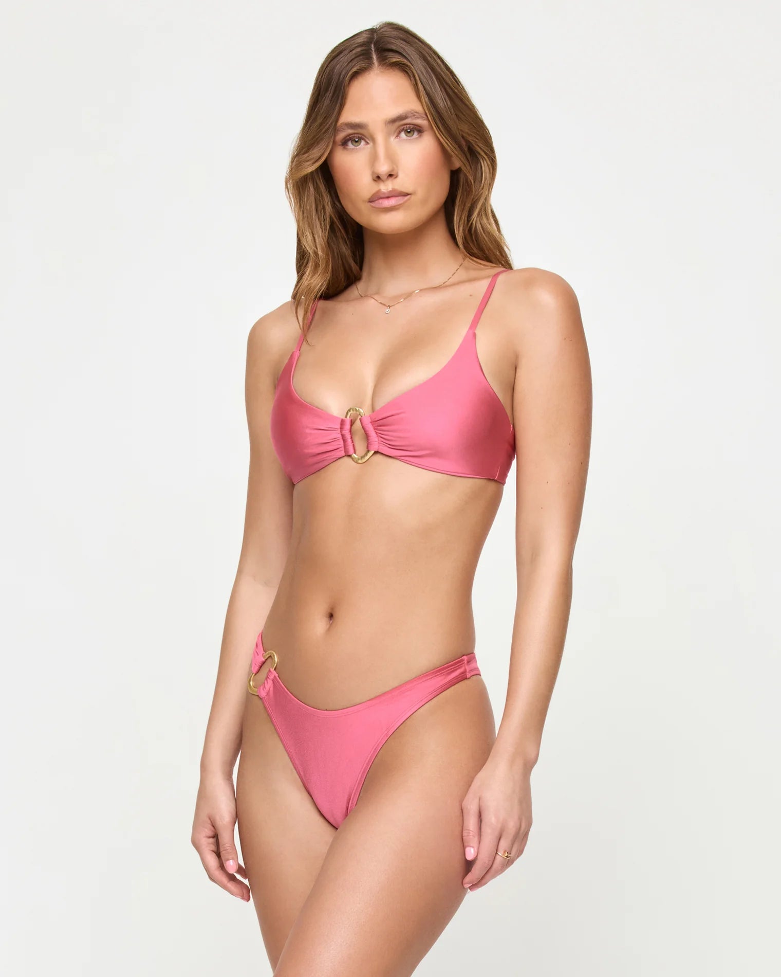 pink bathing suit bikini top with gold hardware in the center