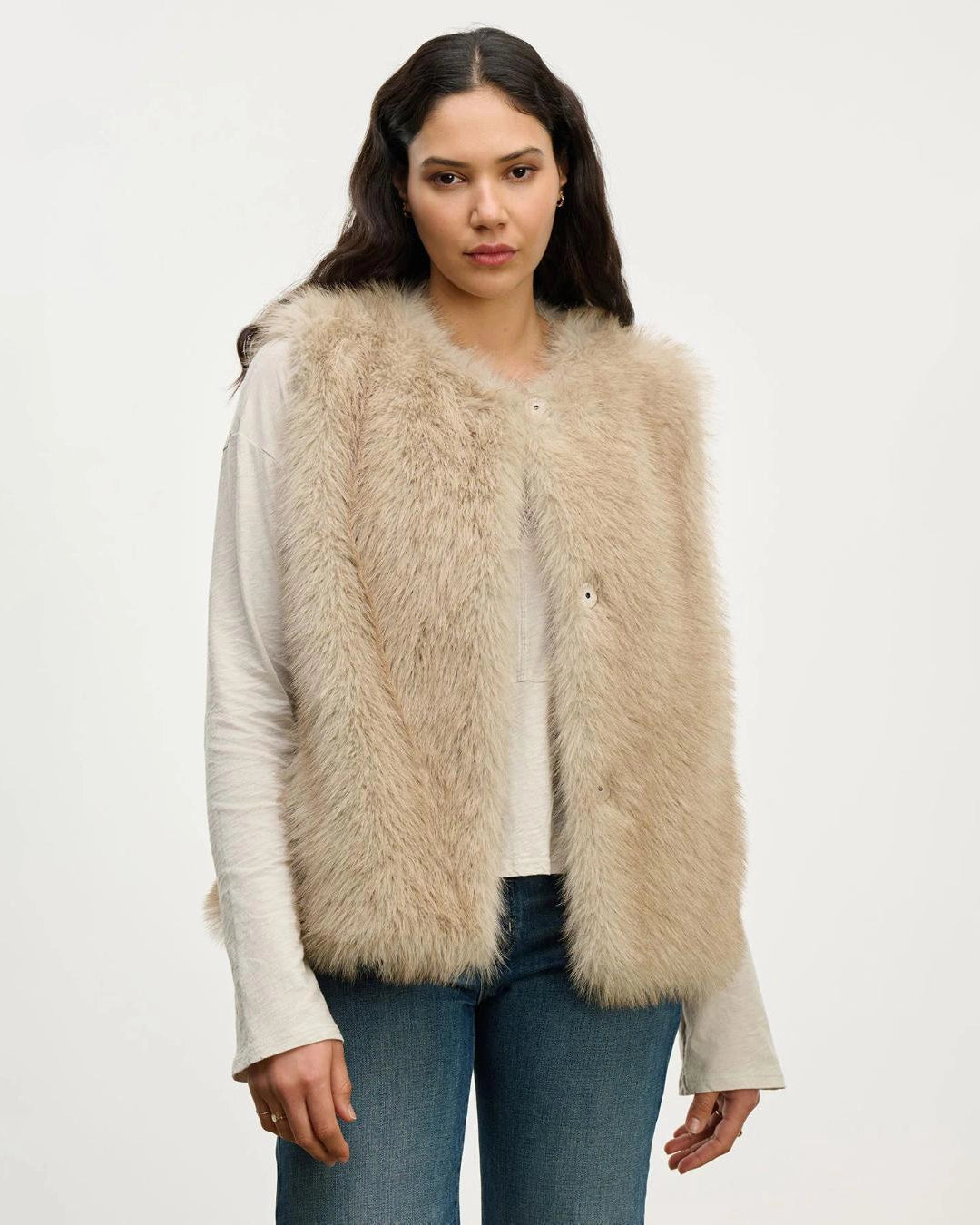 Woman wearing a beige faux fur vest
