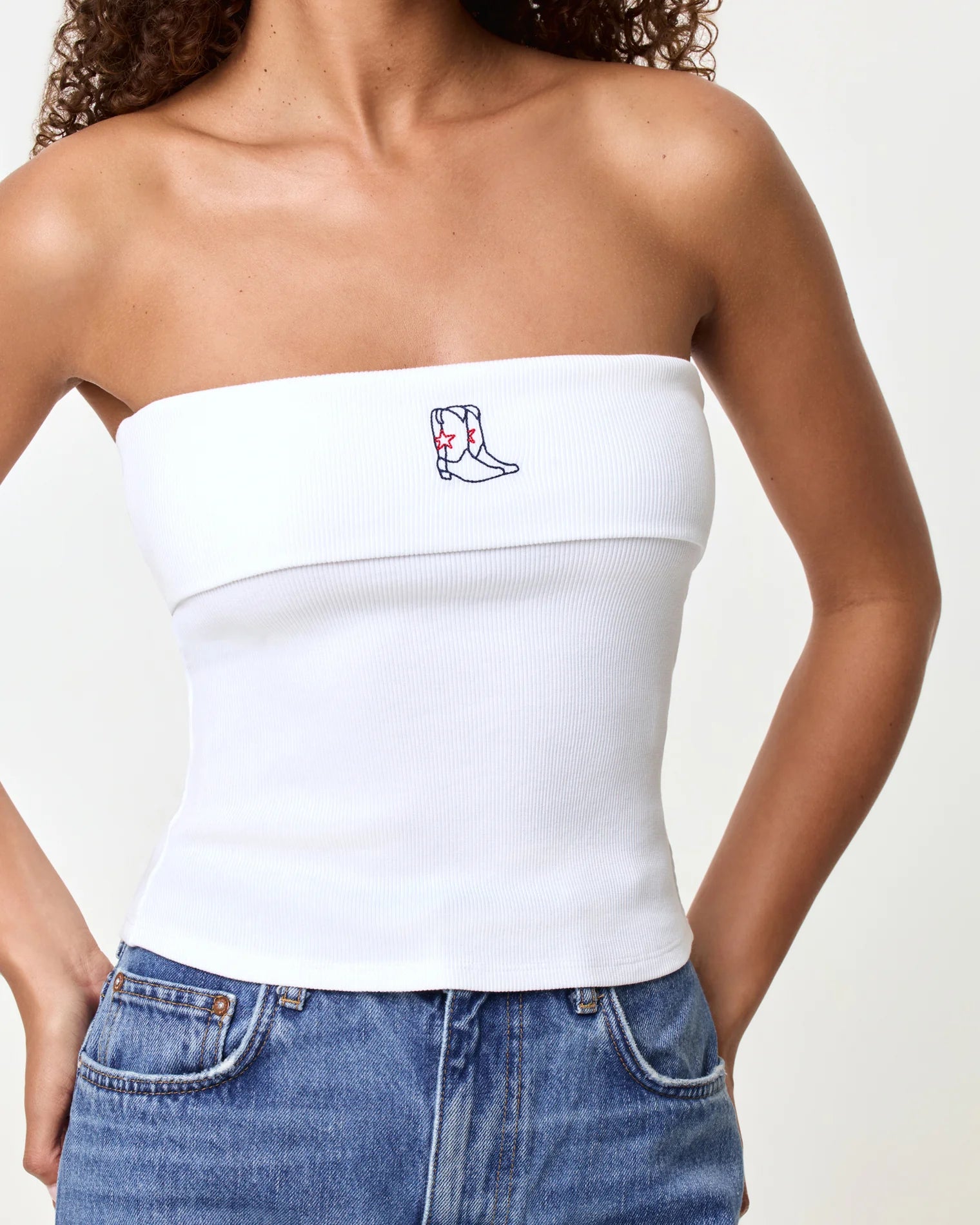 strapless white tube top with cowboy boots embroidered on the top
