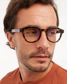 a man wears a pair of brown tortoiseshell bold framed eyeglasses for blue light by Barner