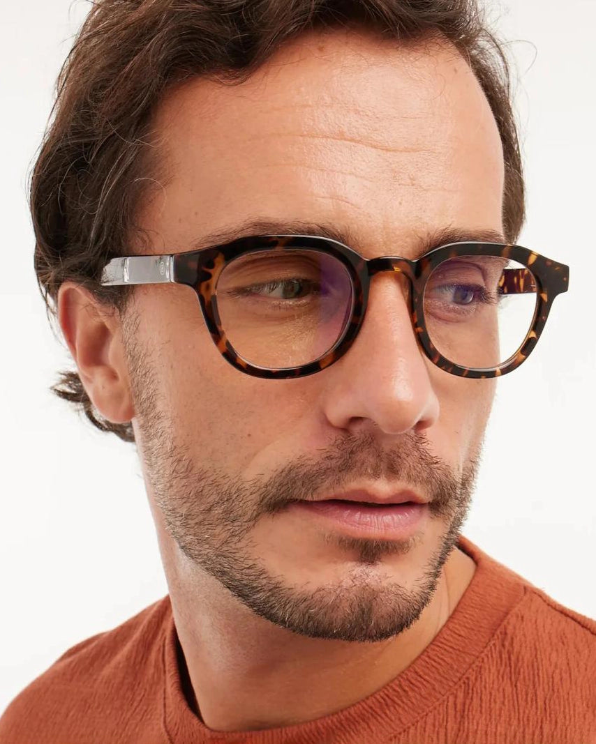 a man wears a pair of brown tortoiseshell bold framed eyeglasses for blue light by Barner