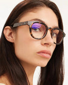 a woman wears a pair of brown tortoiseshell bold framed eyeglasses for blue light by Barner