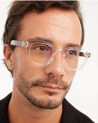 a man wears a pair of clear bold framed eyeglasses for blue light by Barner