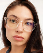 a woman wears a pair of clear bold framed eyeglasses for blue light by Barner