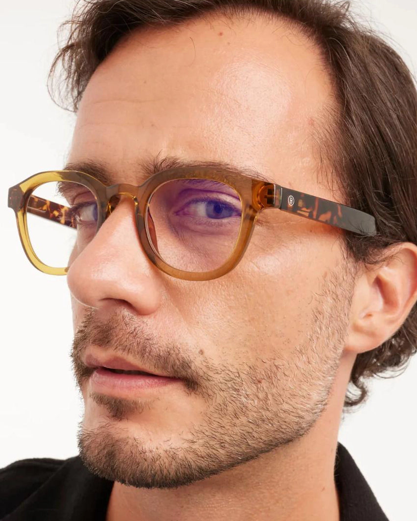 a man wears a pair of tortoiseshell round framed eyeglasses for blue light by Barner