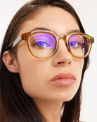 a woman wears a pair of tortoiseshell round framed eyeglasses for blue light by Barner