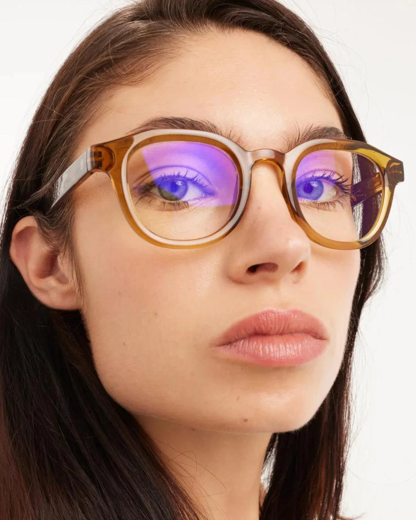 a woman wears a pair of tortoiseshell round framed eyeglasses for blue light by Barner