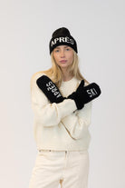 black hat and mitts that say apres ski