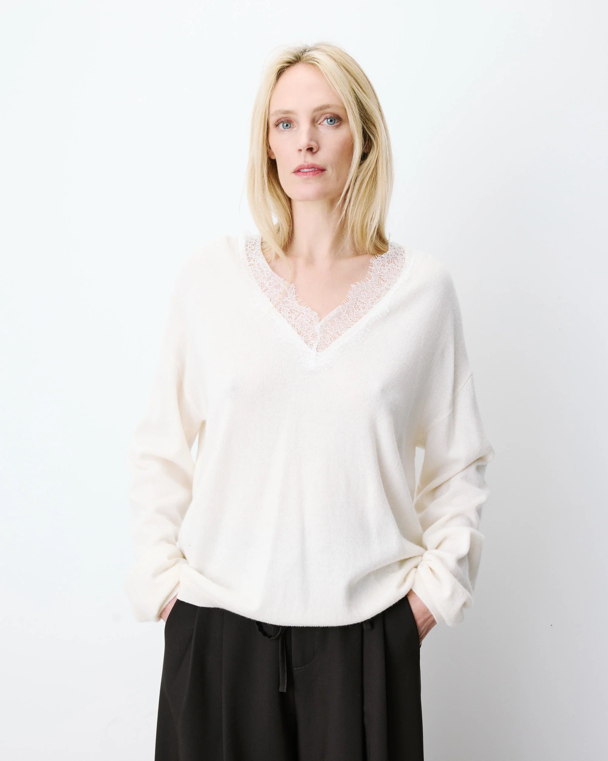 cream knit v-neck sweater with lace trim around neck