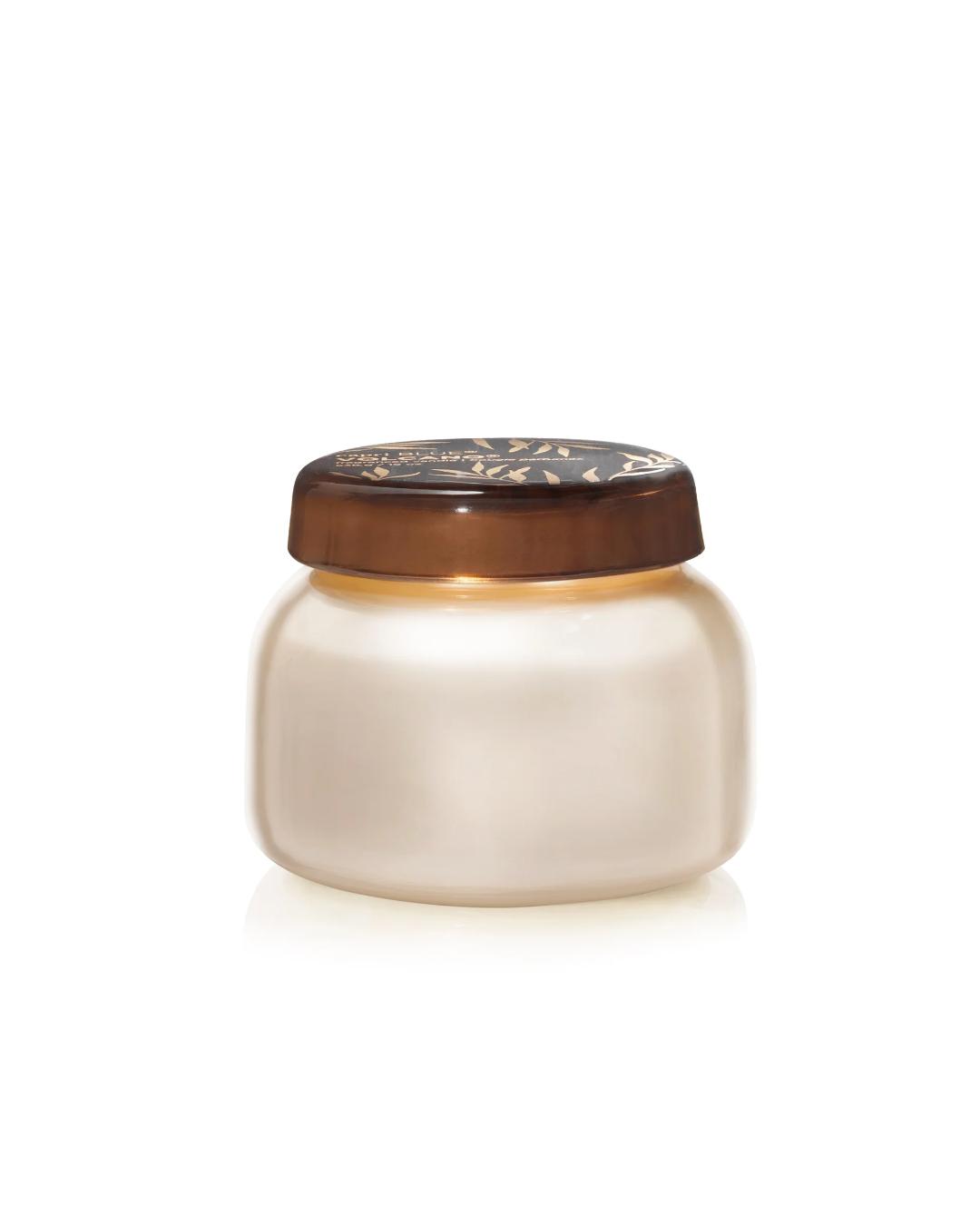 White ceramic jar with a brown lid on a white background